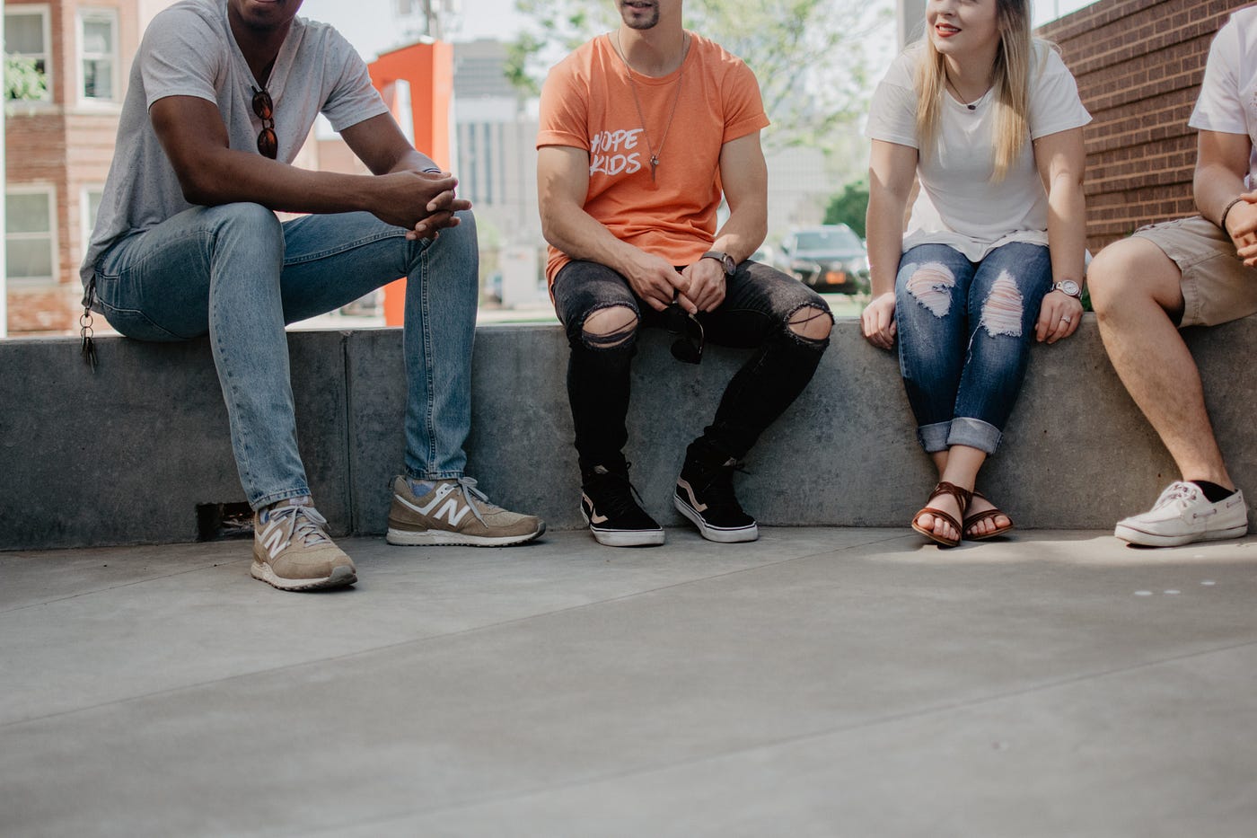 people sitting on concrete blocks party fun