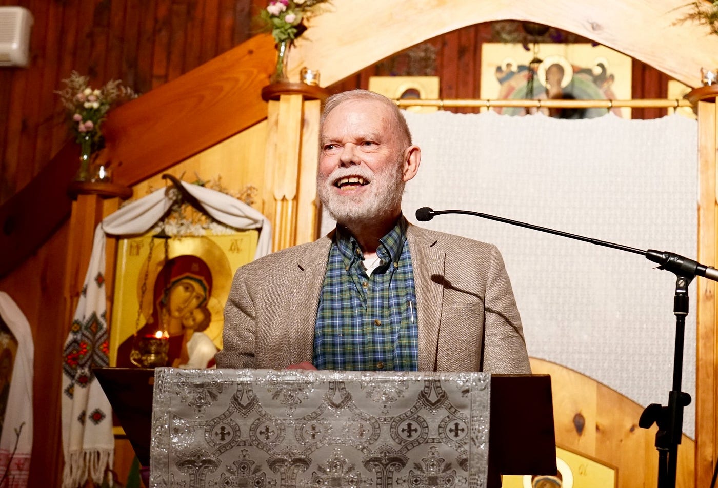 Author and peace activist Jim Forest speaking at a pulpit with icon of Our Mother of Perpetual Help behind him.