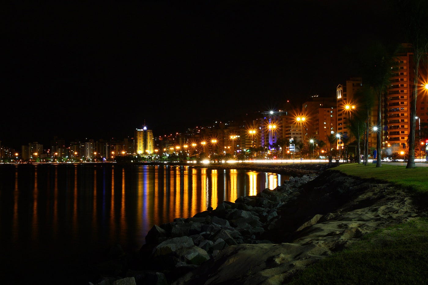 Florianopolis skyline as seen from the seaside at night.