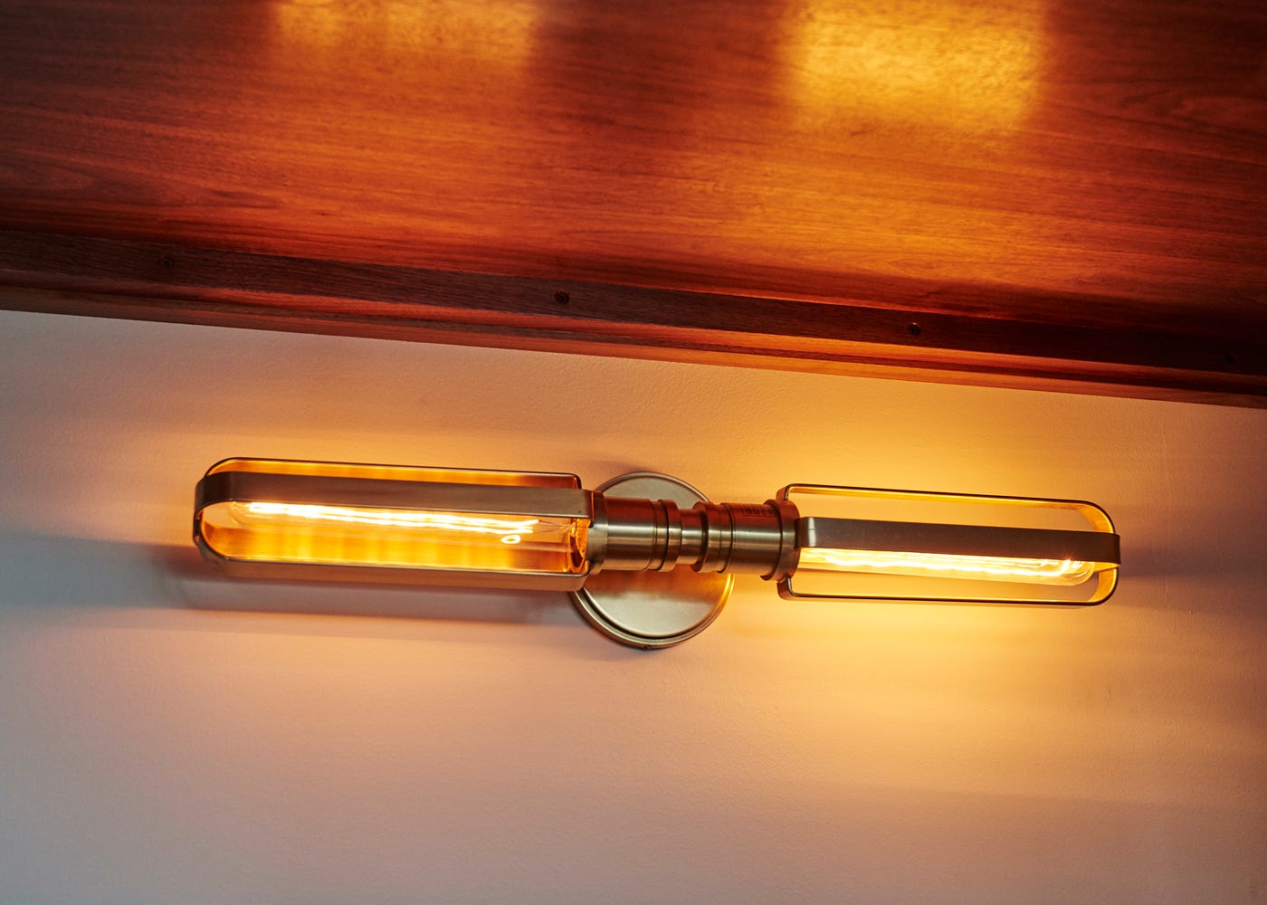 An illuminated antique-brass wall sconce.