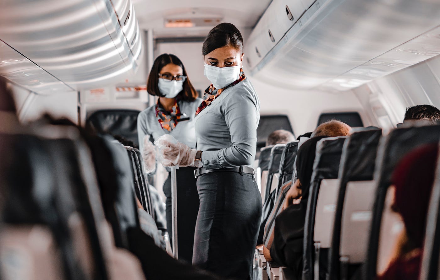 Masked flight attendants on airplane