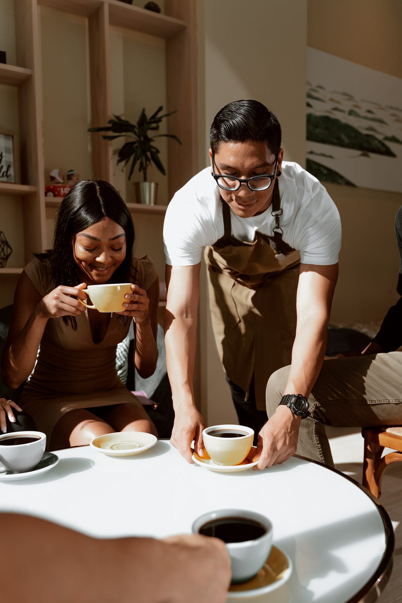 Man serving coffee to customers