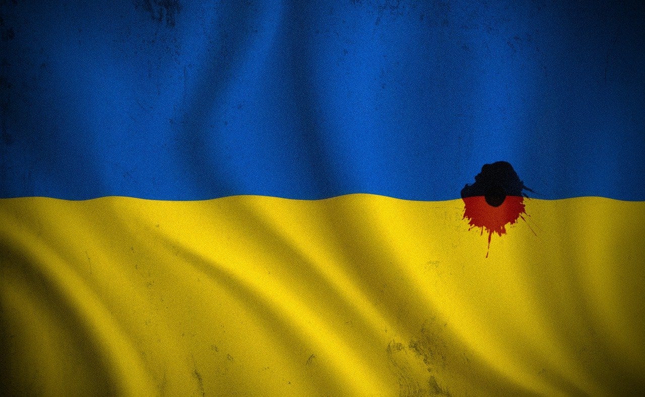 IMAGE: An Ukrainian flag with a bullet hole and blood