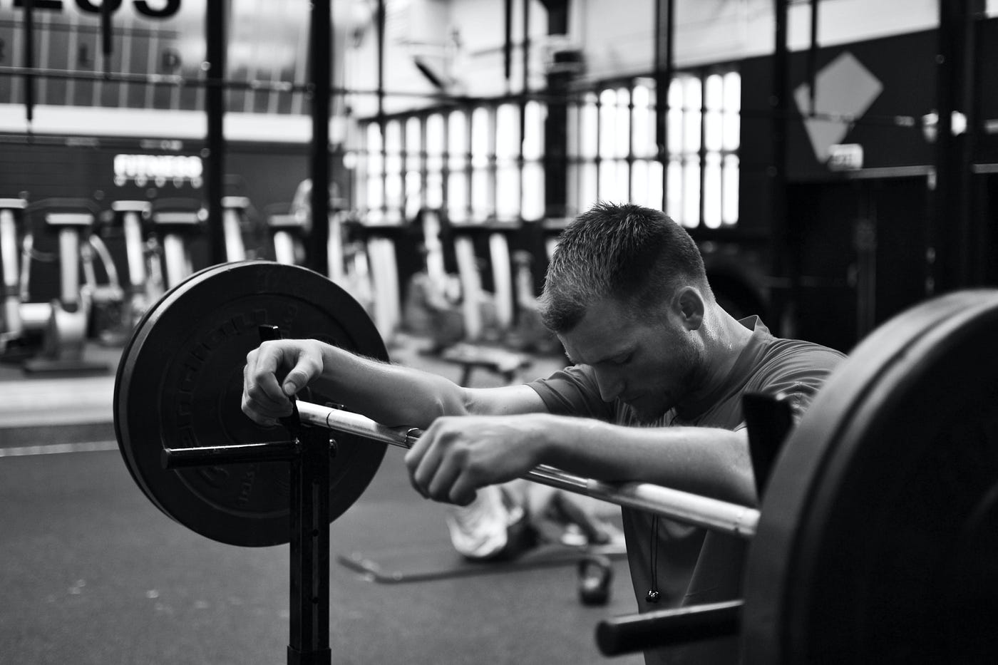 strength athlete leaning over barbell