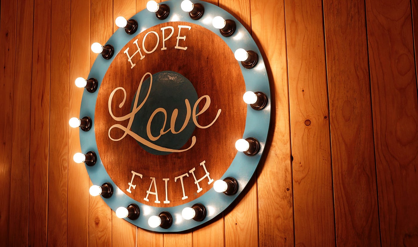 A sign that says Hope, Love, and Faith