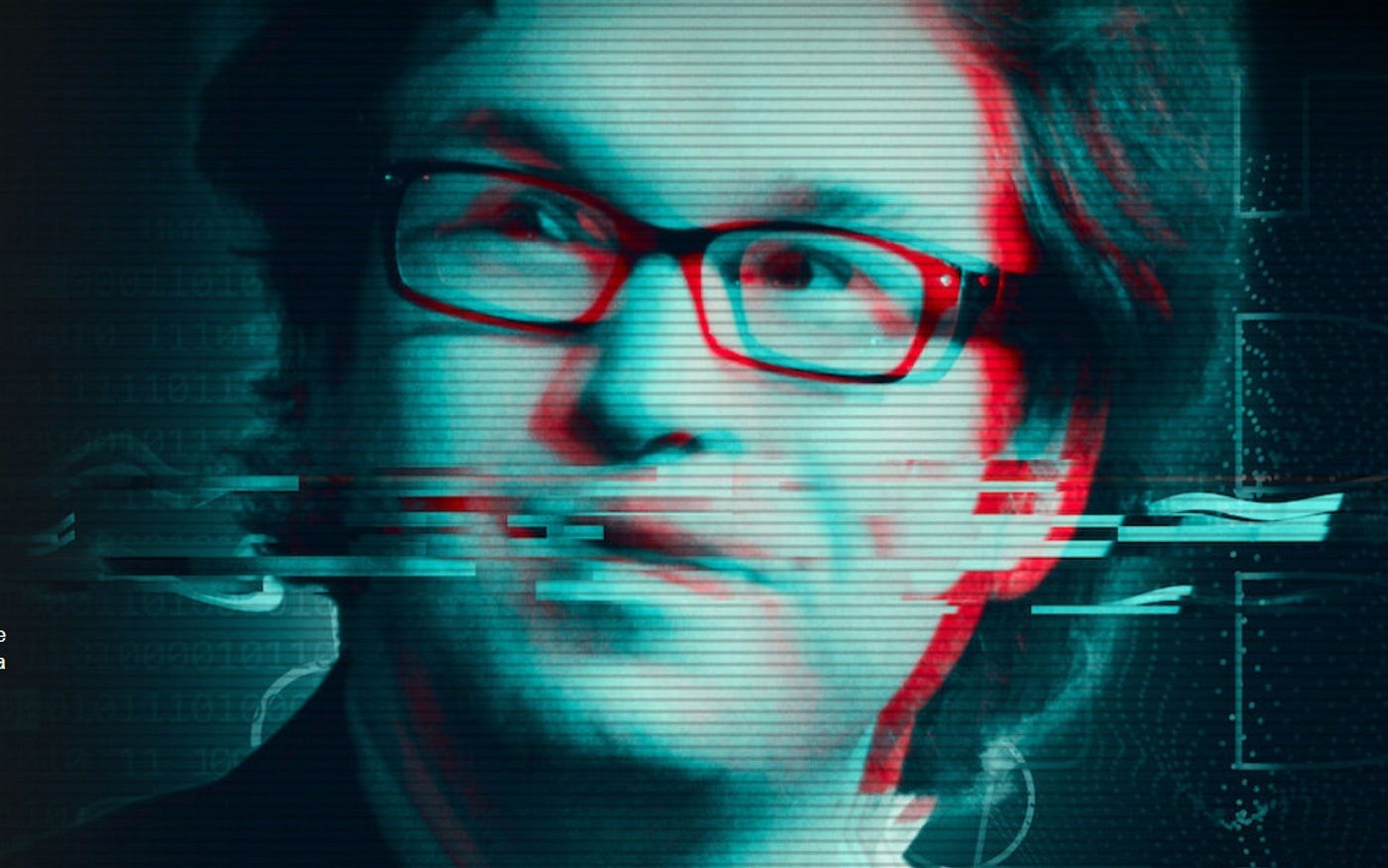 A distorted close-up picture of Gerald Cotten with medium length floppy hair and wearing thick black glasses