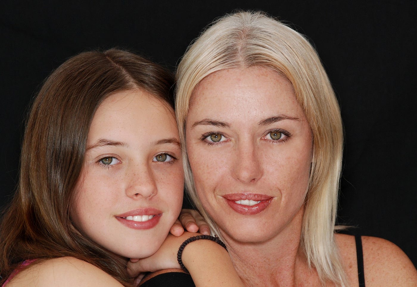 Close-up shot of mother and daughter smiling