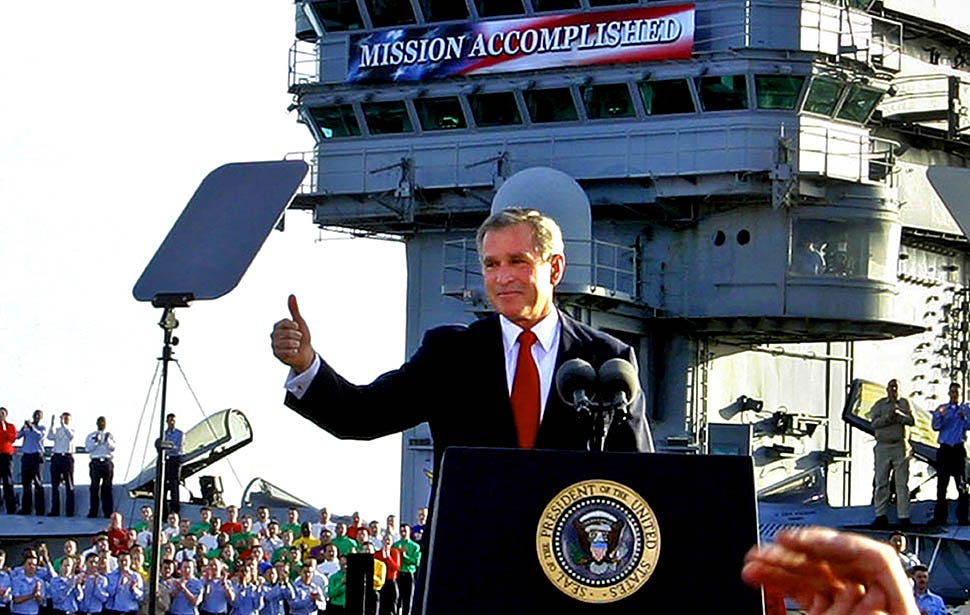 Pictured: George Bush Jr at his Mission Accomplished speech. Having used the same tactic of fabricating WMD hysteria to the public.