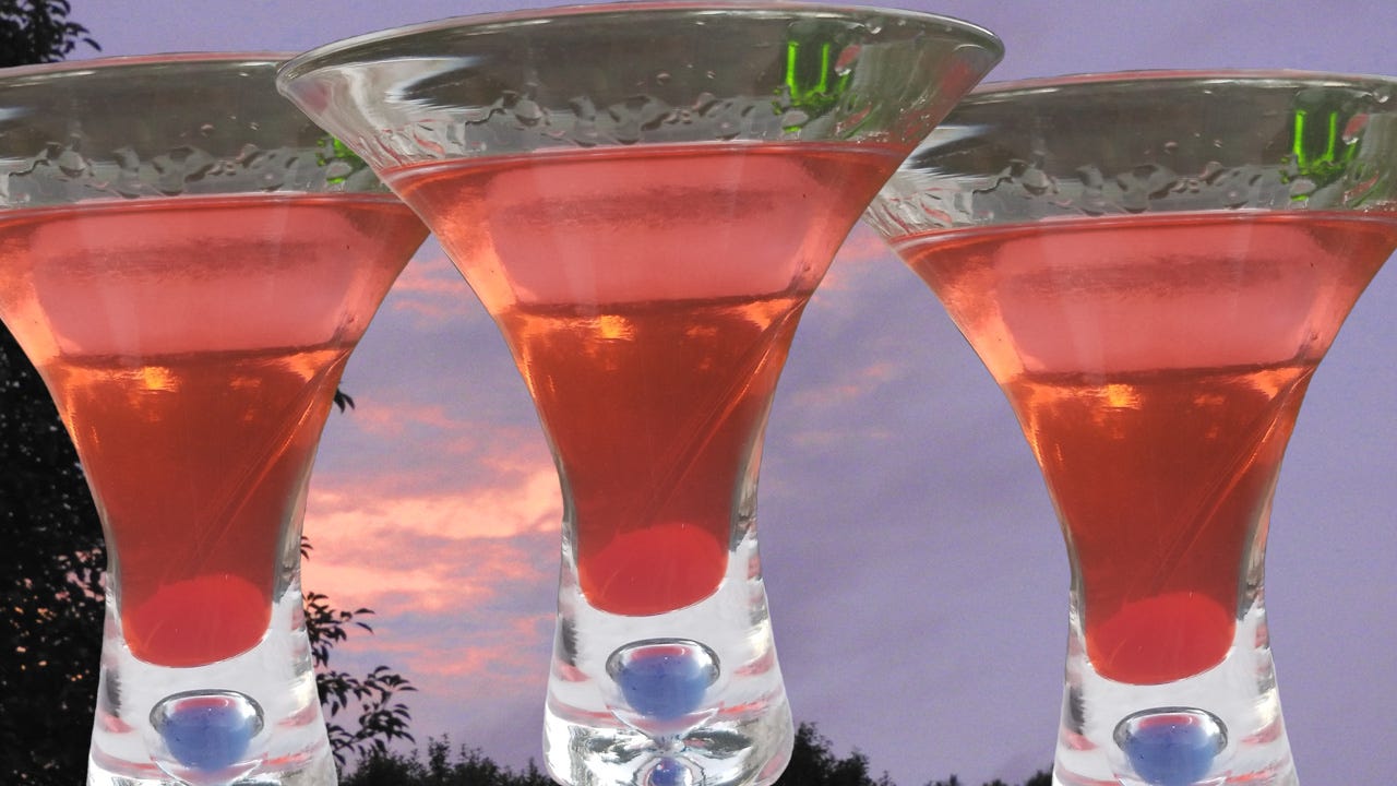 Some fancy chocolate cherry martinis against a sunset