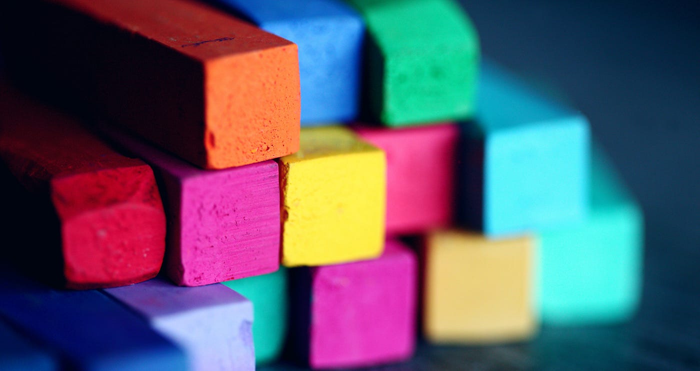 Brightly coloured building blocks stacked loosely on top of each other.