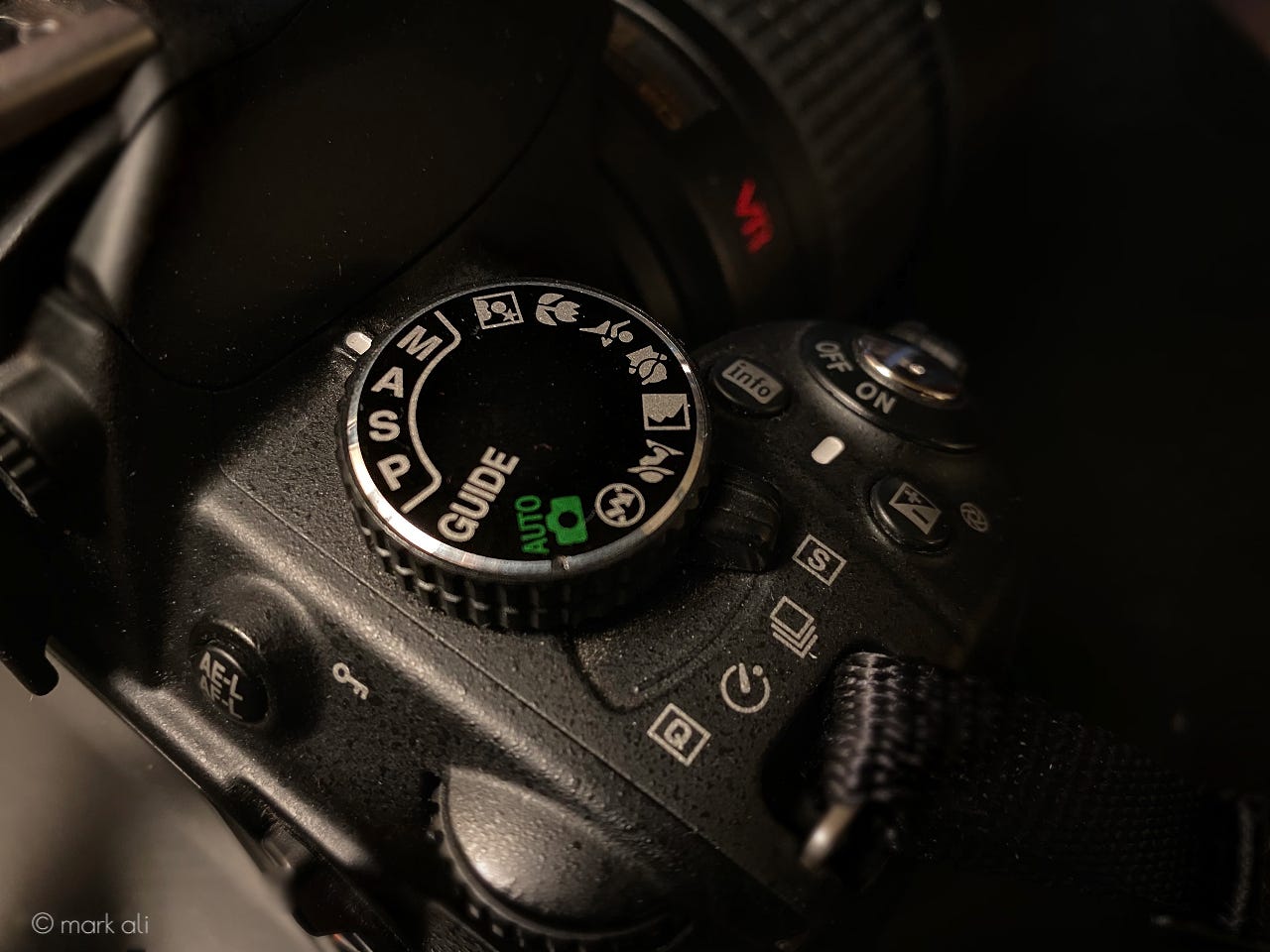 A mode dial on top of a camera.