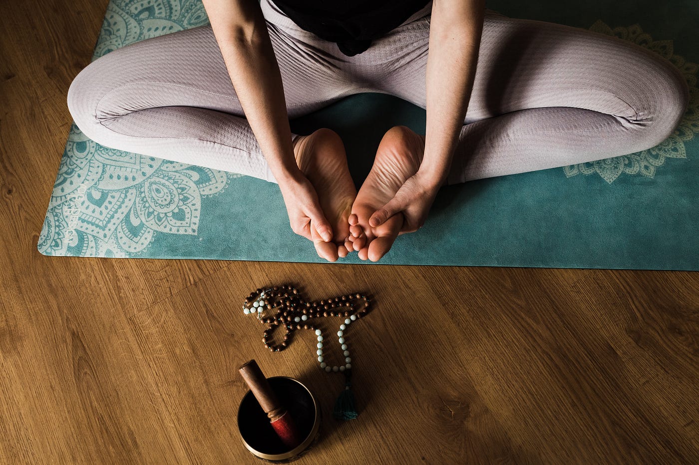 A women doing yoga with healing bowl