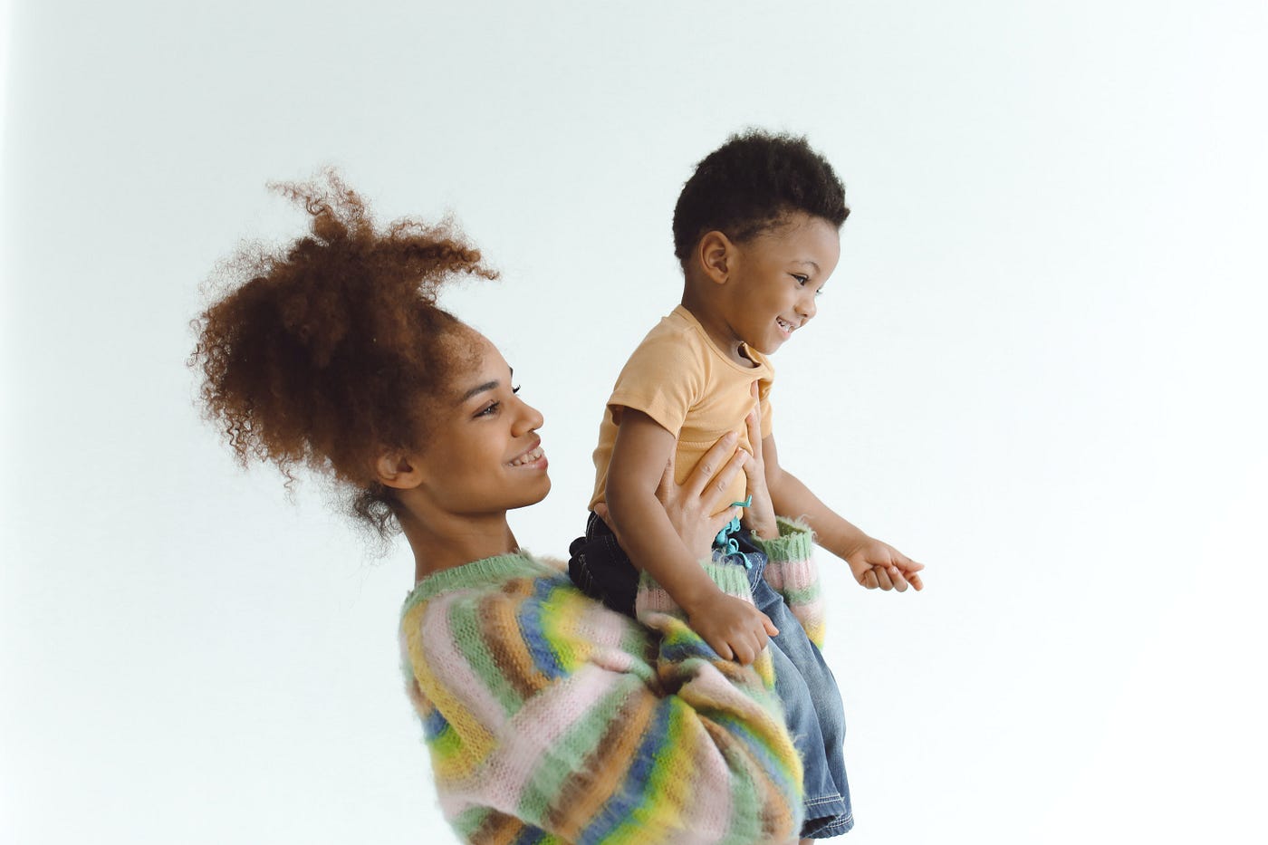 A mom holding up her son