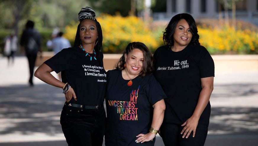 Tiffany Willoughby-Herard, Jessica Millward, and LaShonda R. Carter stand in a line together smiling