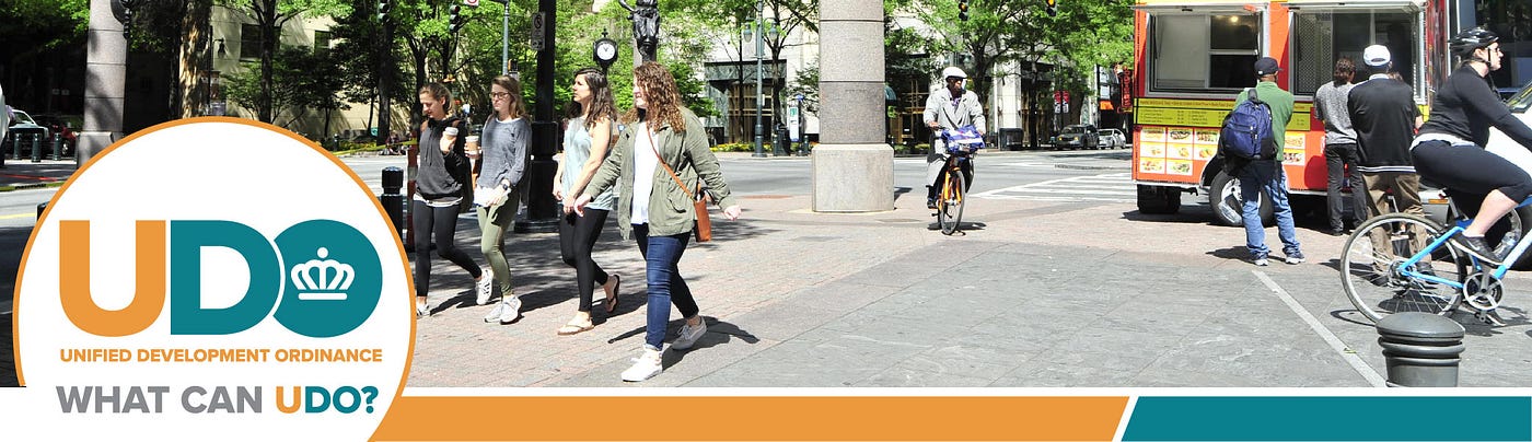 People walking, biking in streets of Uptown Charlotte