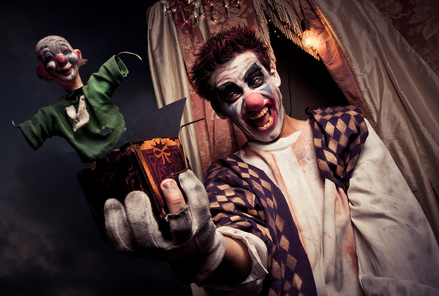 A scary clown holding a jack in the box toy — Picture from Depositphotos.com