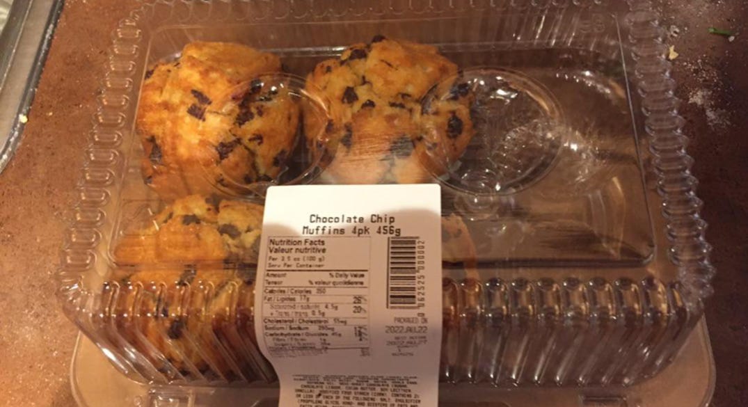 Four muffins in a container for six.