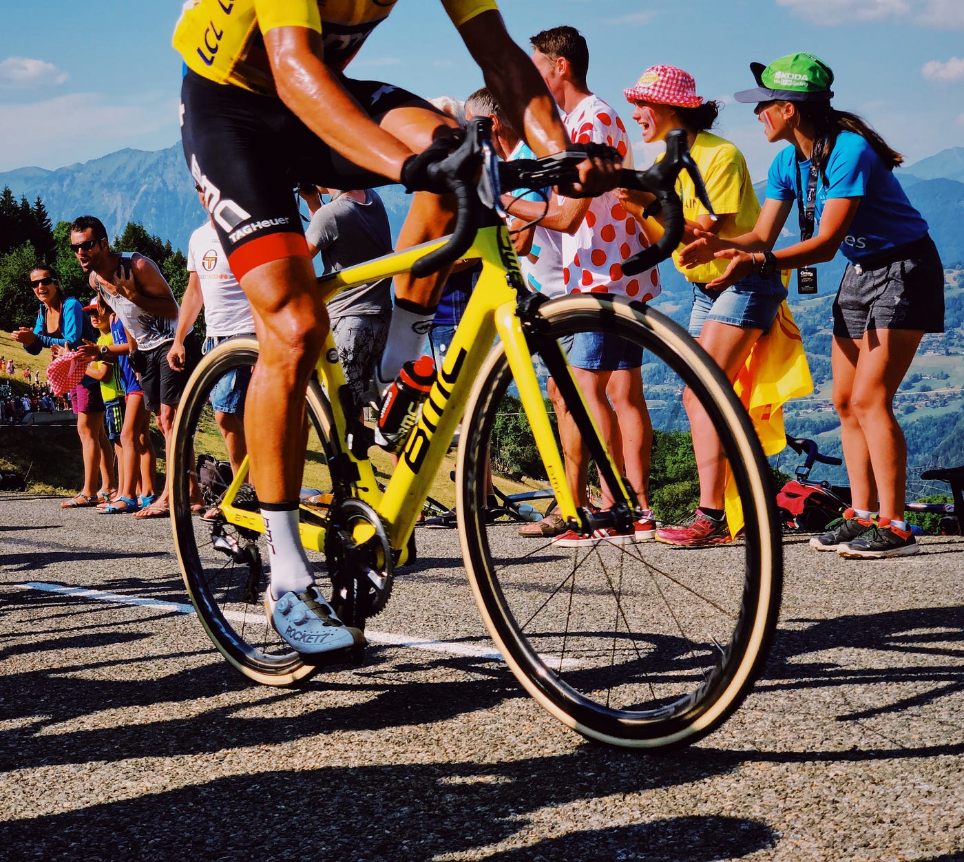 A cyclist being cheered on by fans