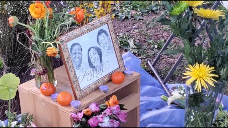 An artist drawing of victim and family, propped up at grave.