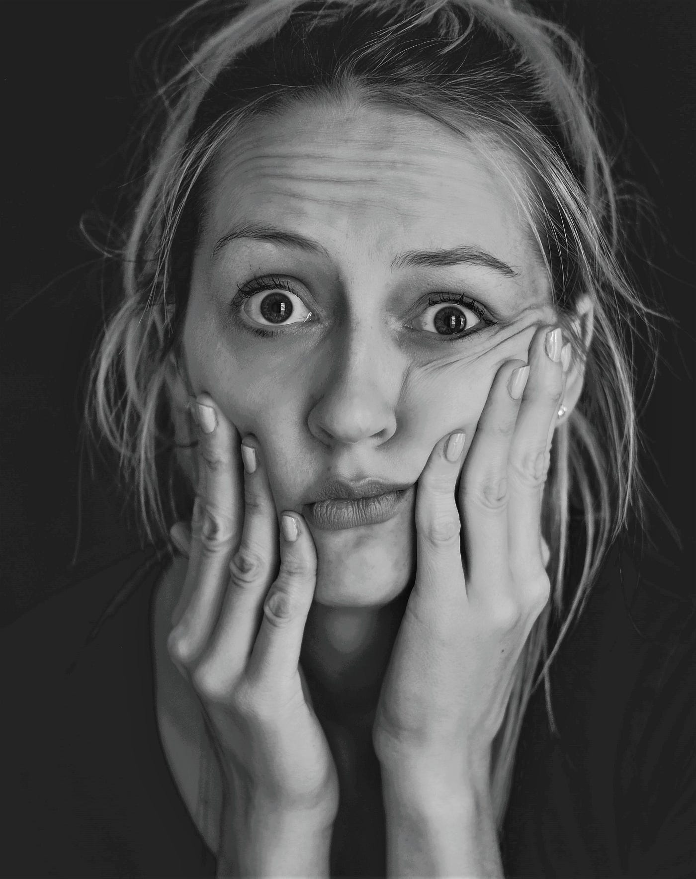black and white photos of confused girl with hands on cheeks