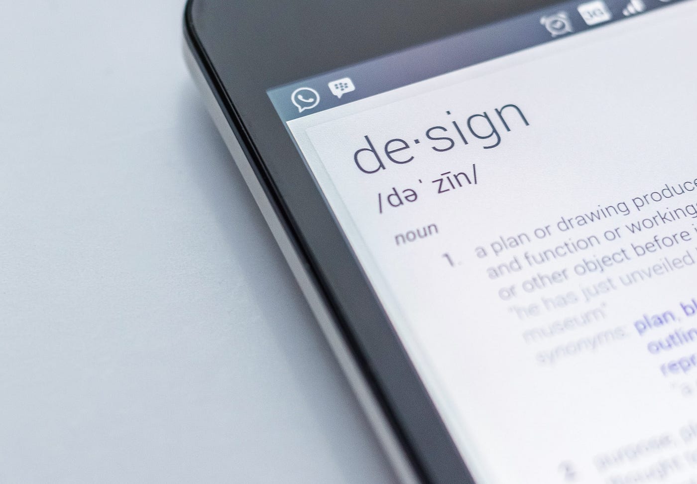 Smart phone screen showing the definition of the word design