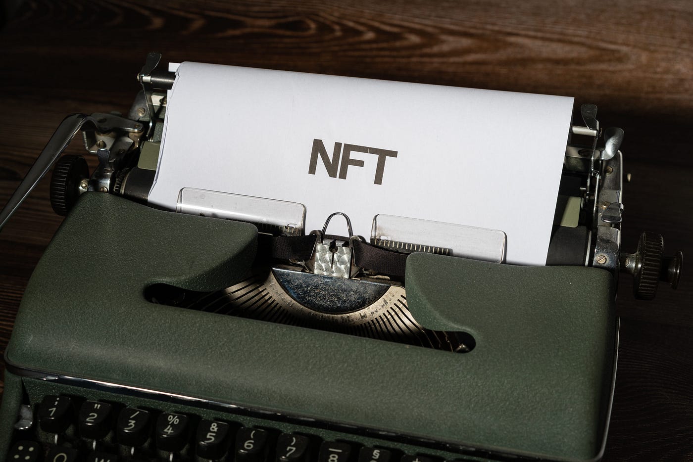 Paper in typewriter with “NFT” on it