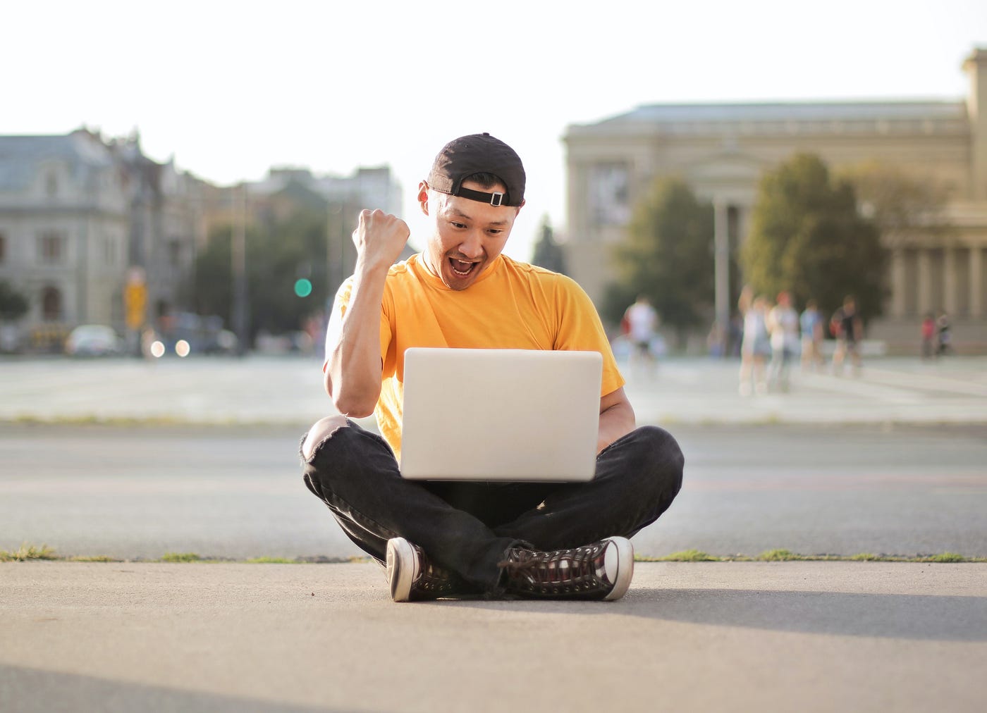 Digital Nomad works on street with laptop