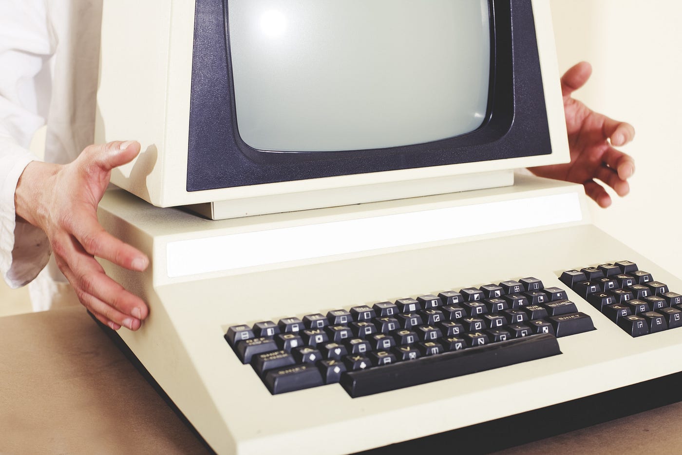 Someone presenting an old computer.