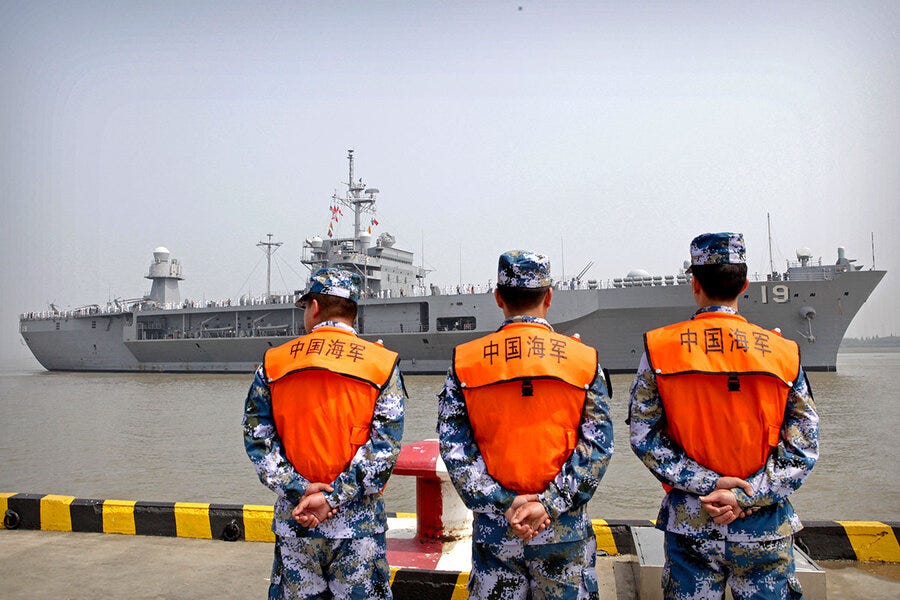 AP/file — Sailors from the Chinese navy watch as the U.S.S. Blue Ridge arrives in Shanghai on May 6, 2016.