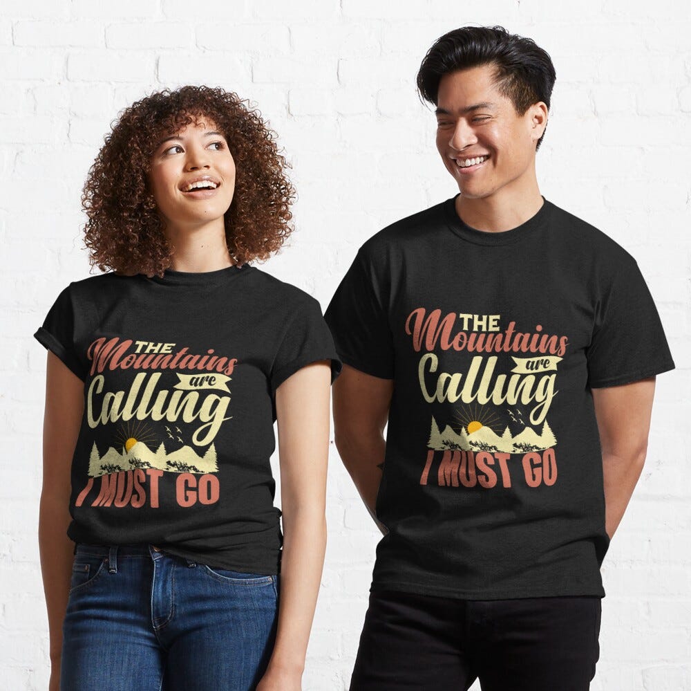 Man and Woman Wearing a black classic t-shirt with amazing illustration and text saying “the mountains are calling and i must go”.