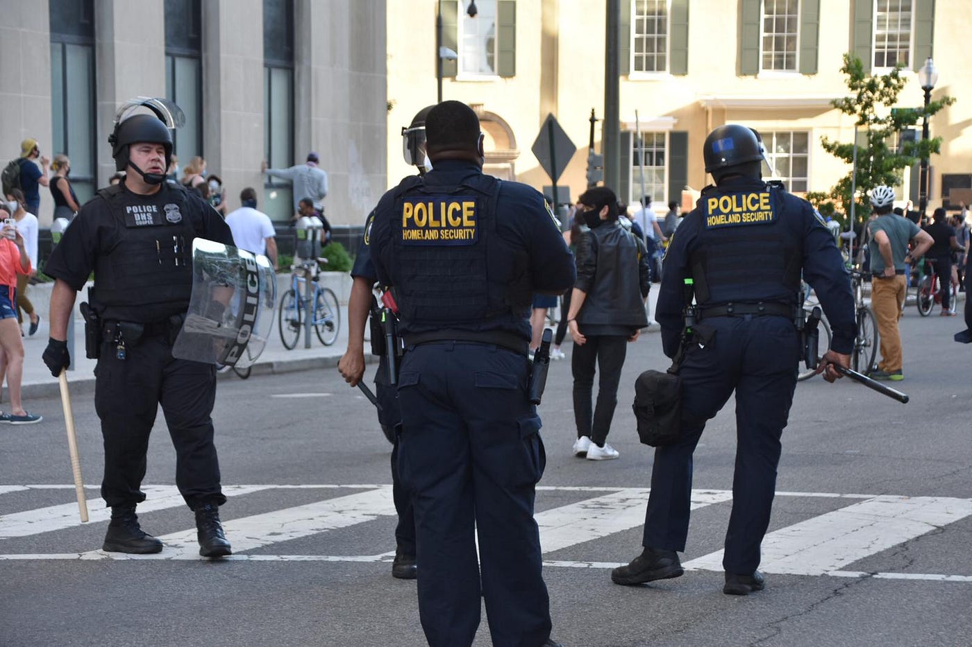 Police officers in helmets holding batons and shields on 16th Street in Washington D.C.