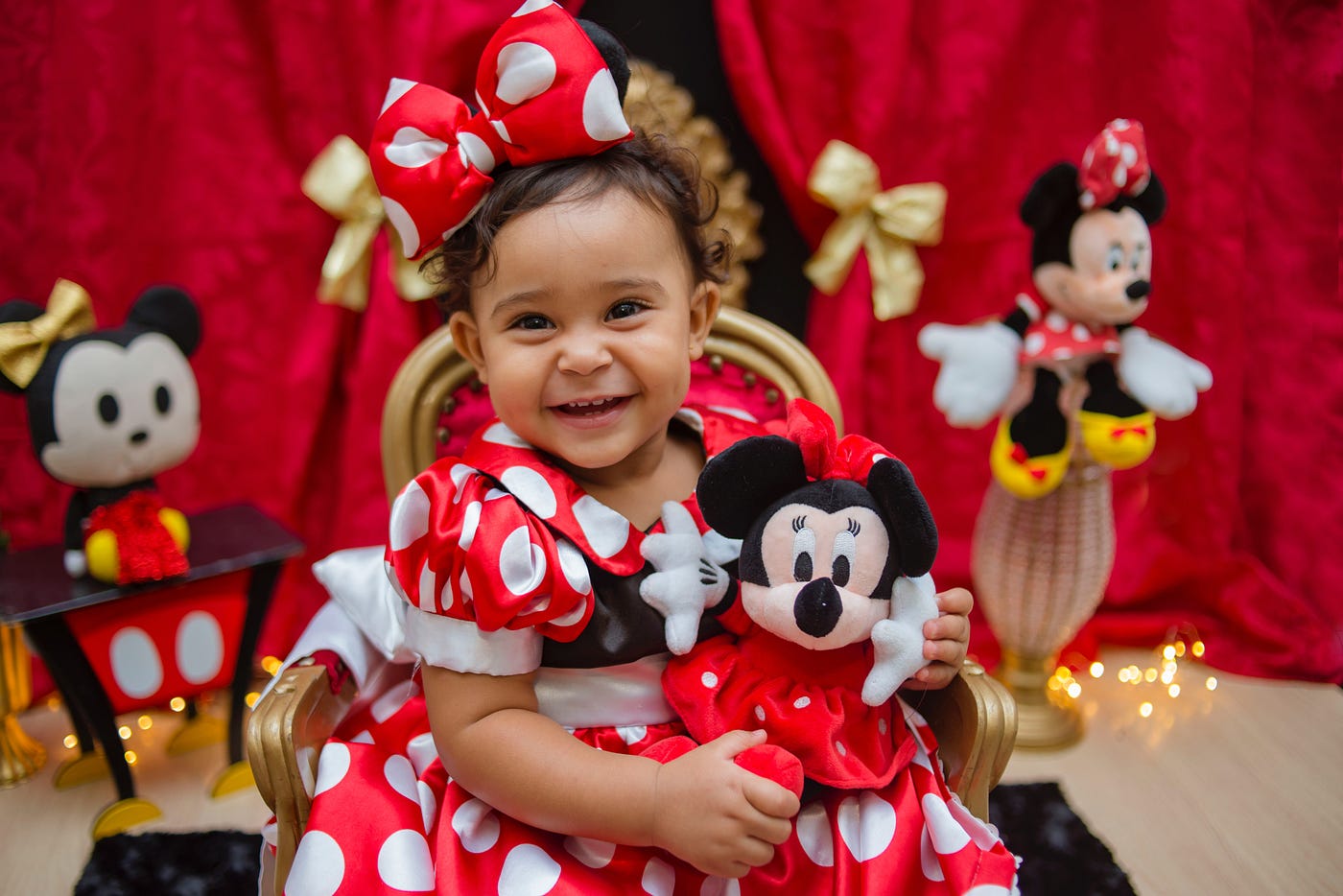 Girl in Red and White Polka Dot Dress Holding Mickey Mouse Plush Toy