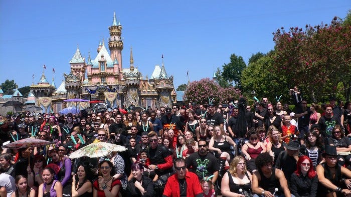 A group photo from 2008’s ‘Bat’s Day in the Fun Park,’ featuring a vast crowd of goths in front of the Disneyland castle.