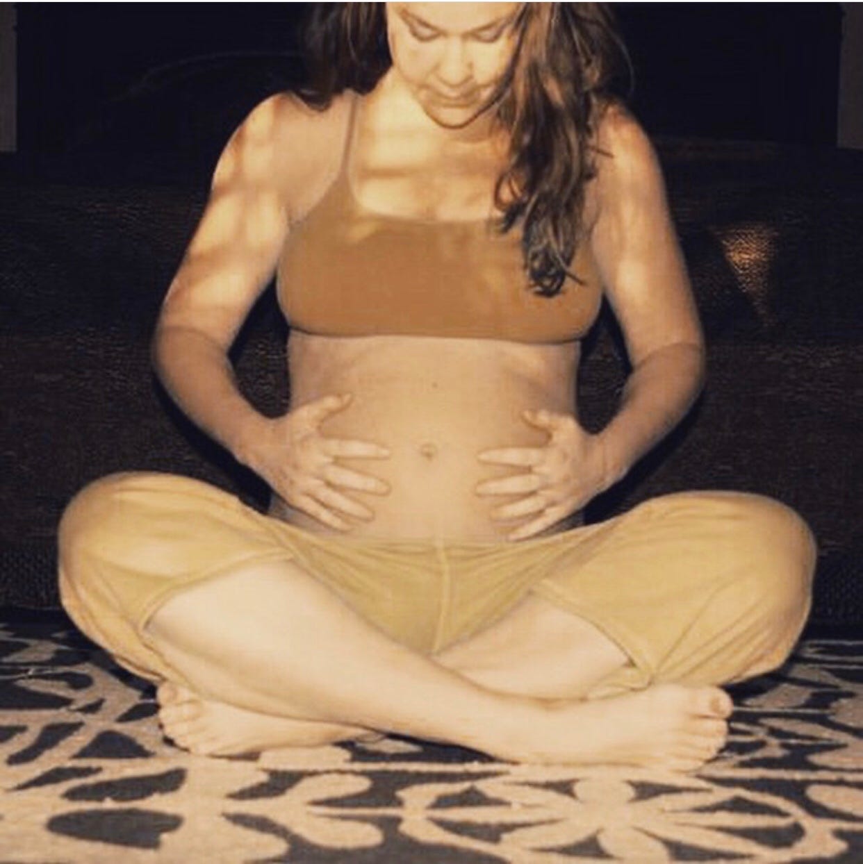 A pregnant woman doing prenatal yoga, concerned about weight gain in pregnancy.