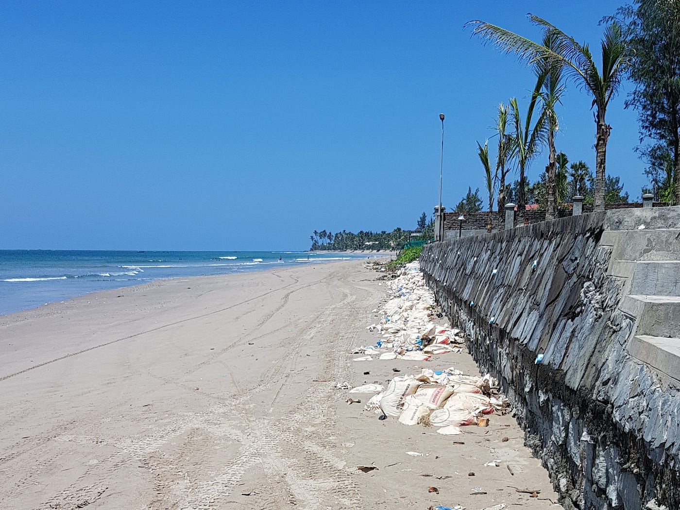 Photo of beach front with rests of construction (i.e. trash)