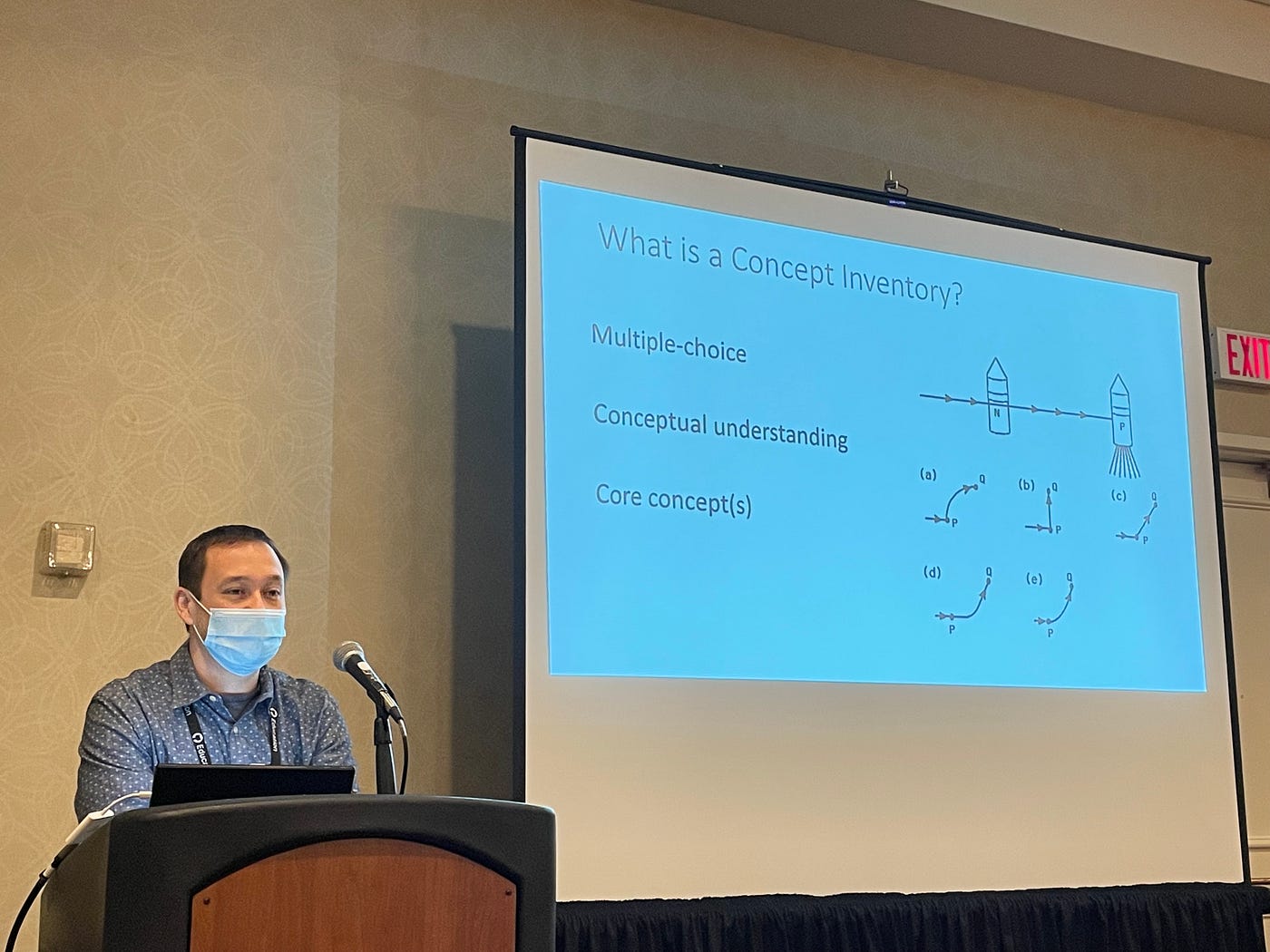 Geoffrey Herman at a podium and a slide showing a physics concept inventory example item.
