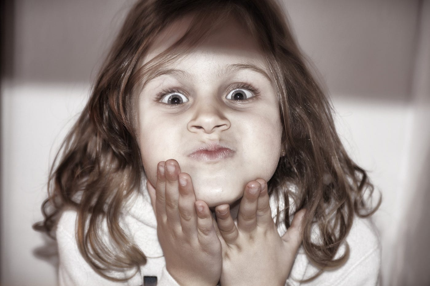 Close up of a toddler girl making a silly face in fun