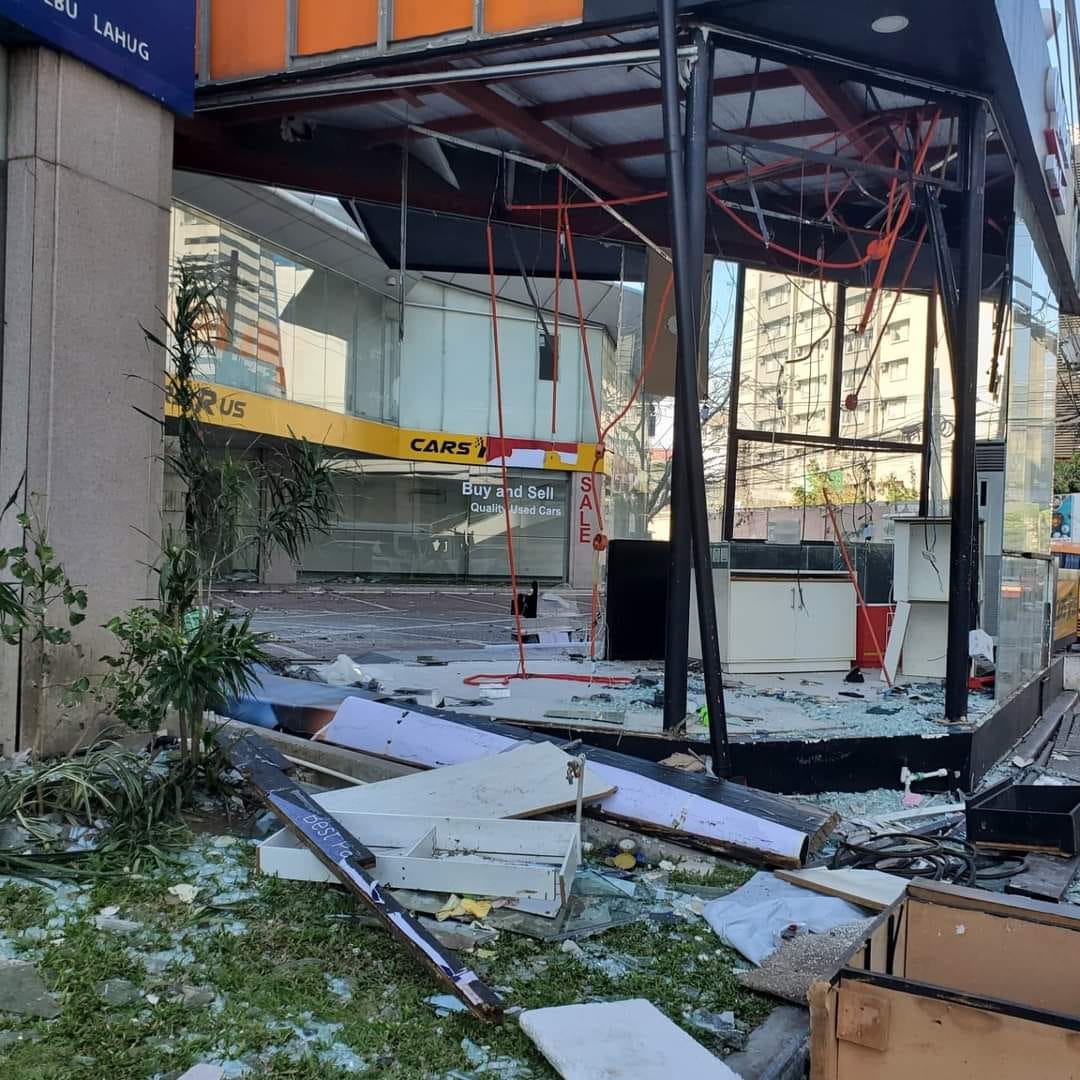 A picture of a busines establishment with broken glass and debris lying around everywhere