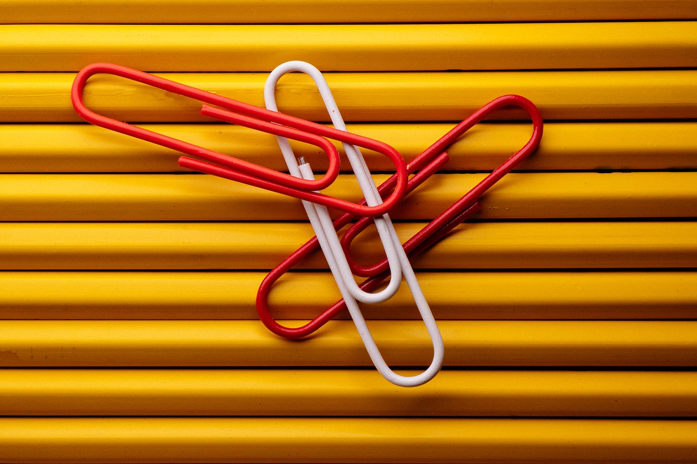 Paper clips resting on pencils.