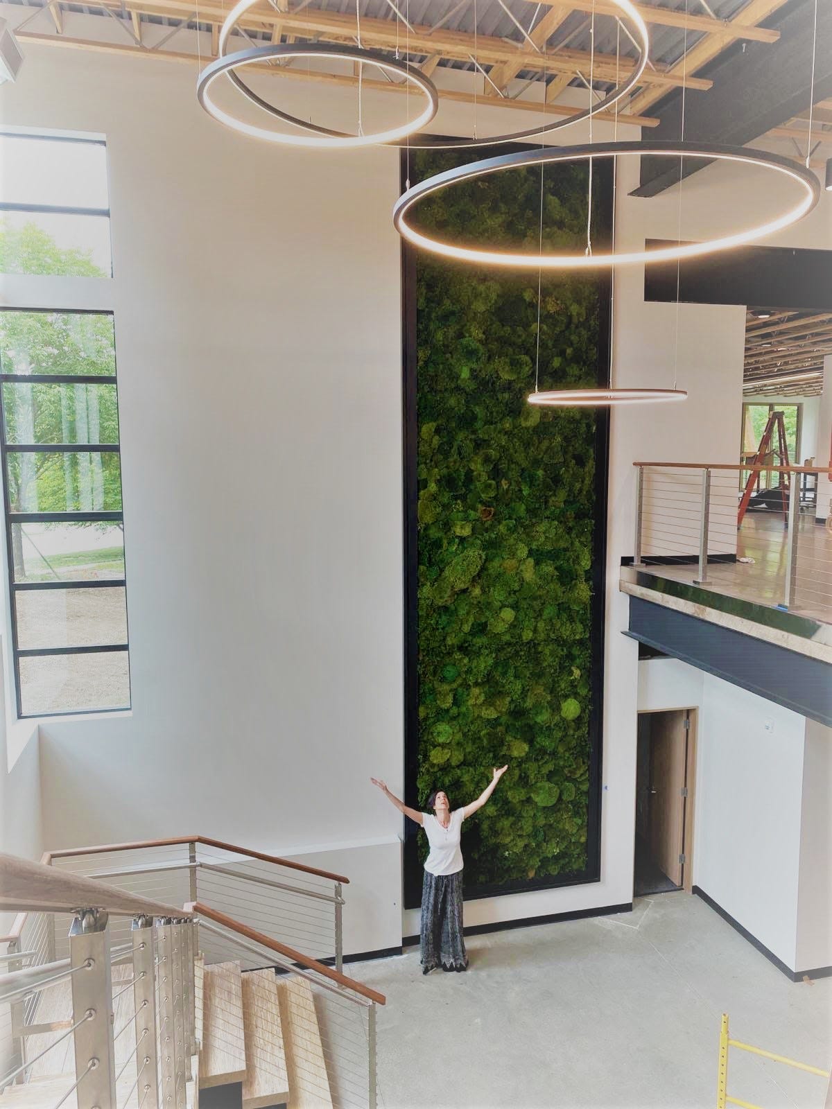 A multi-floor pillow moss wall welcomes visitors to Navitas and Smith & Boucher Engineering offices.