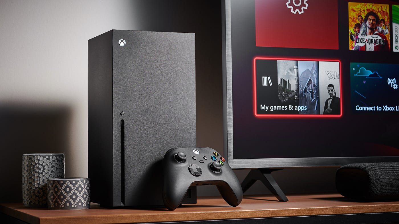 Living room with a Microsoft Xbox Series X home video game console alongside a television and soundbar