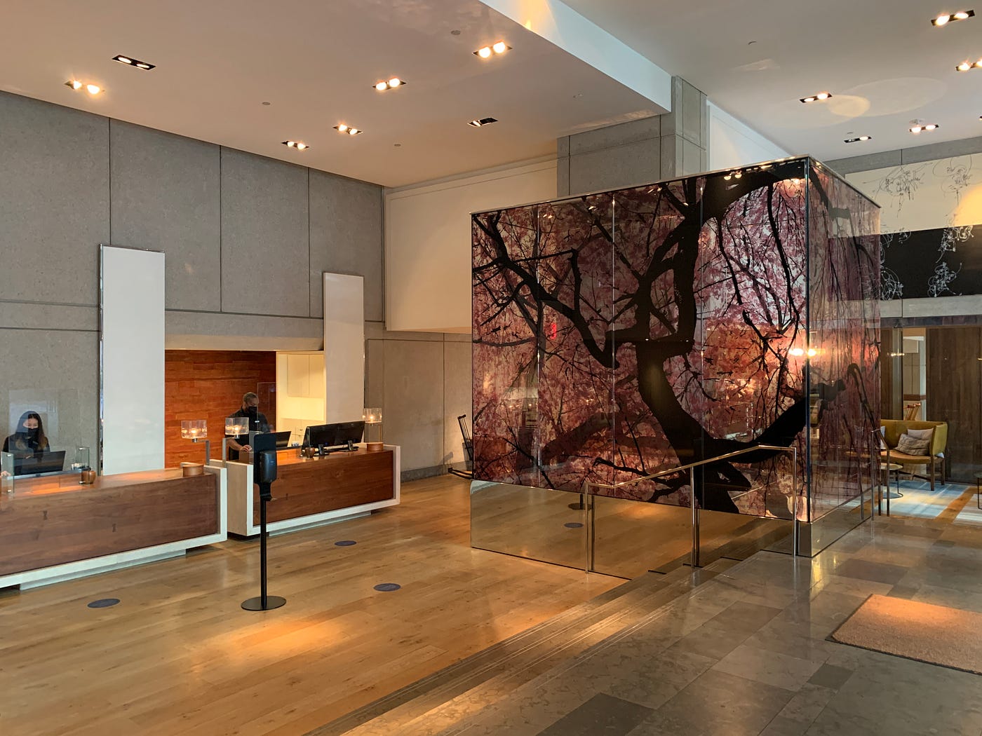 Park Hyatt Washington D.C.’s lobby and front desk which has a painting of a cherry blossom tree on glass.