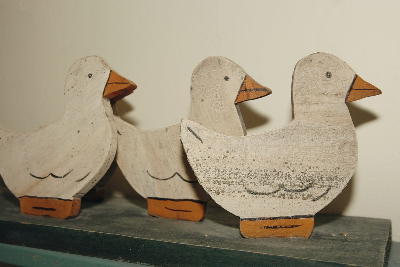 3 wooden ducks lined up in a row