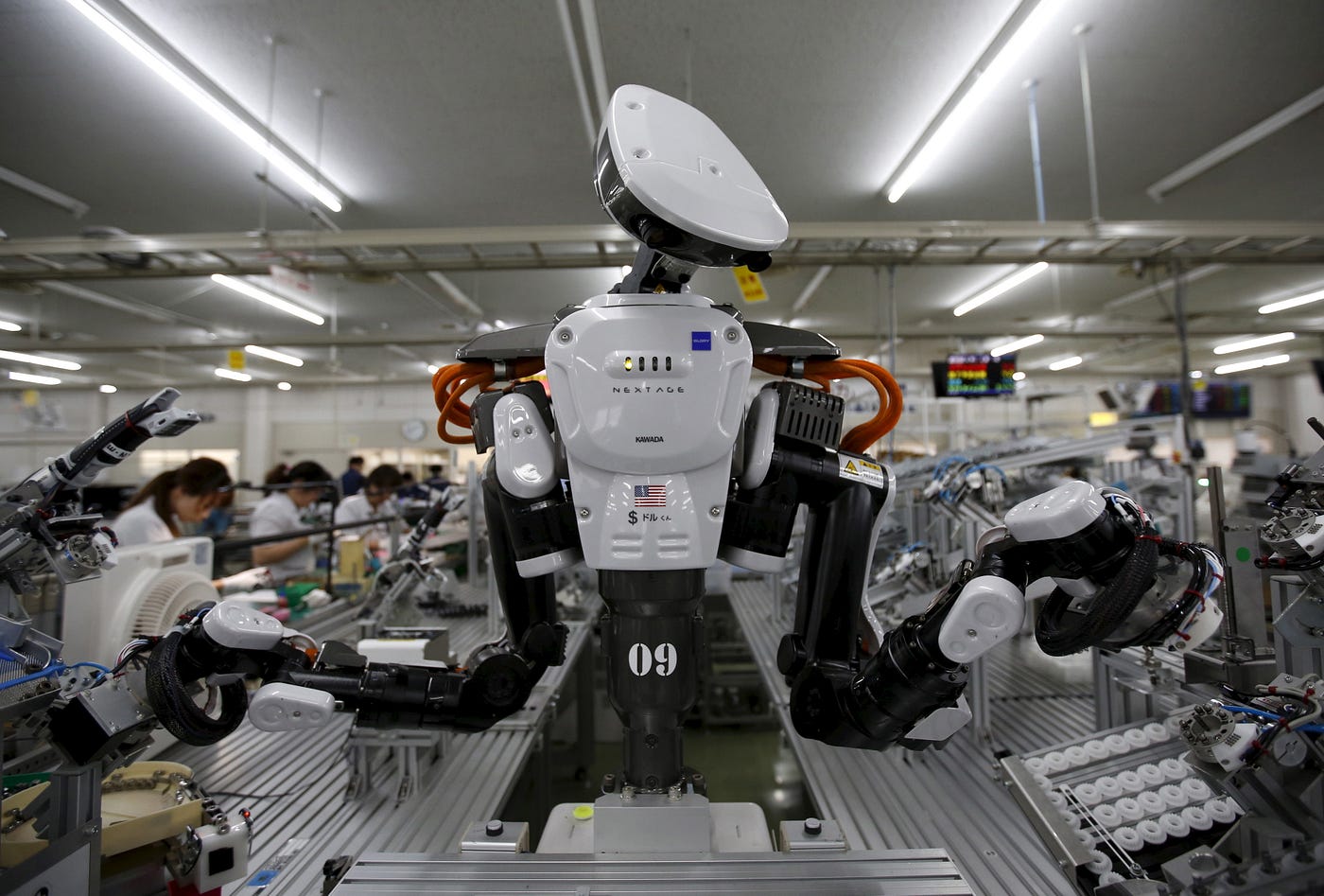 A humanoid robot works side by side with employees in the assembly line at ...