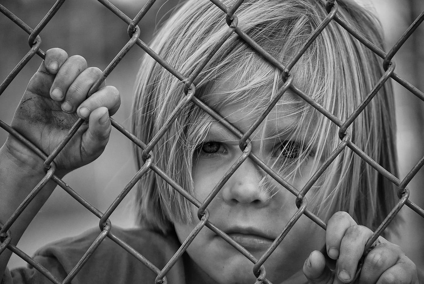 Sad child, behind bars