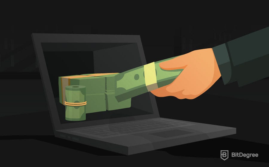 Hand taking money from a computer