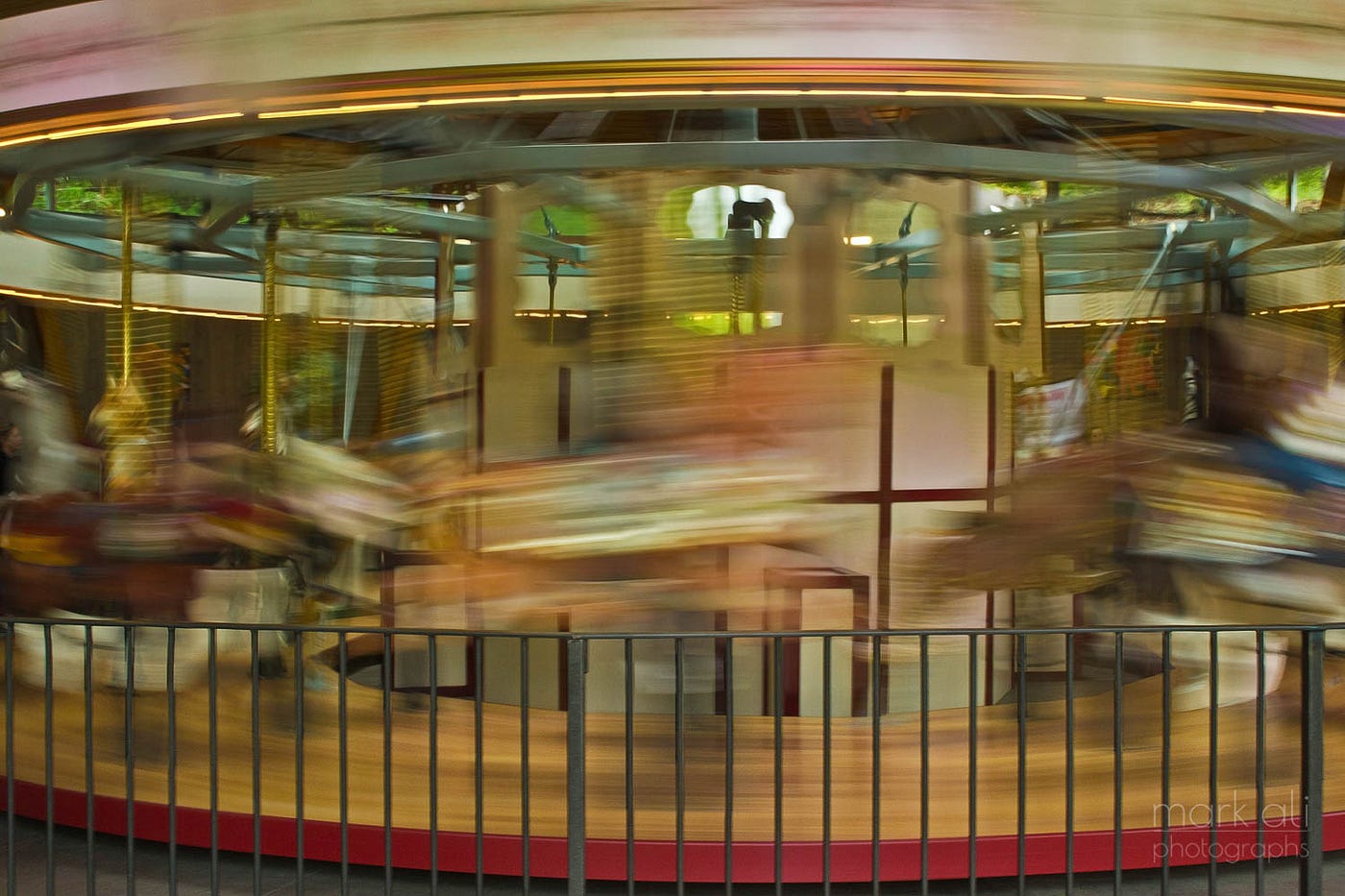 An image of a merry-go-round (carousel), with blurring to depict motion.