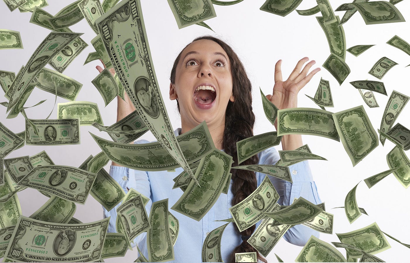 Image of excited woman yelling excitedly as money falls out of the sky