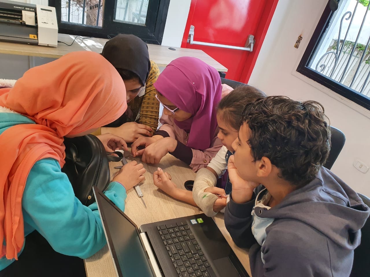 Five young students take measurements for a project.