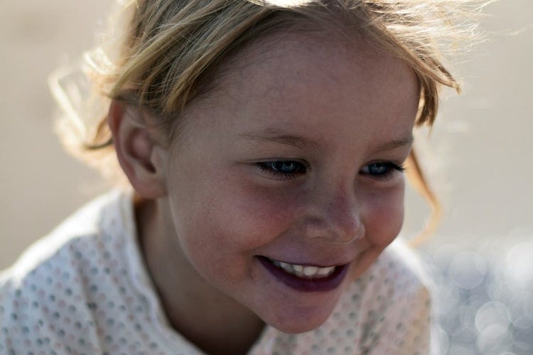 A happy 5-year-old girl with a smile